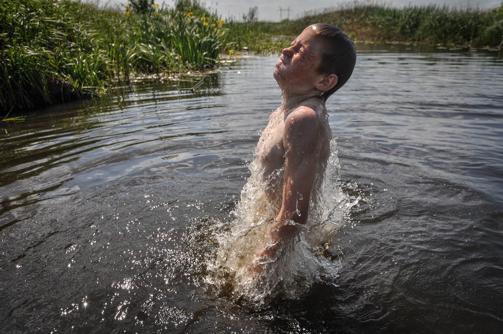 A boy swims in a river that runs through the Chernobyl nuclear Exclusion Zone in Ukraine