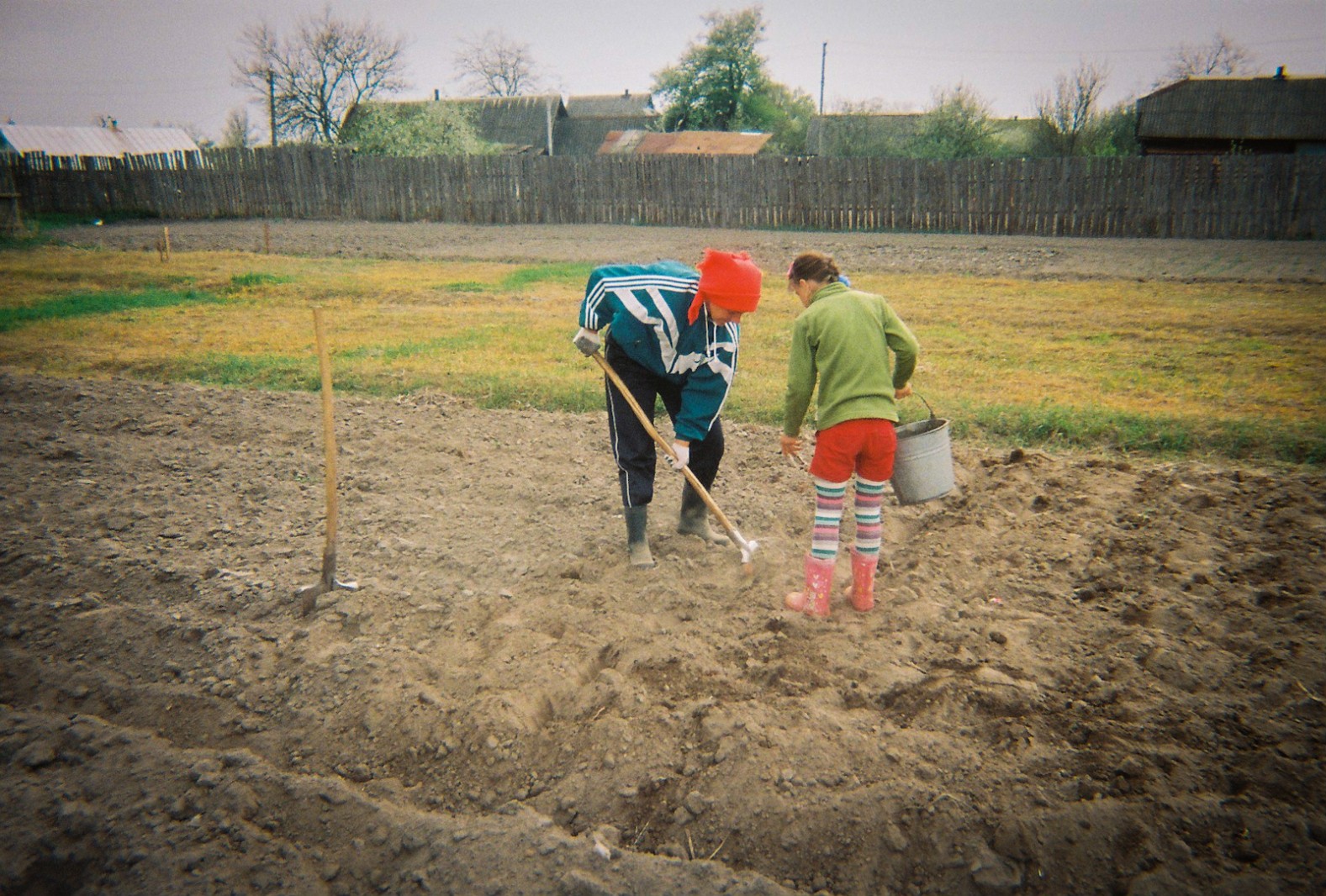 A mother and her daighter plant potatoes during April, the same month that Chernobyl polluted this landscape almost thirty years earlier