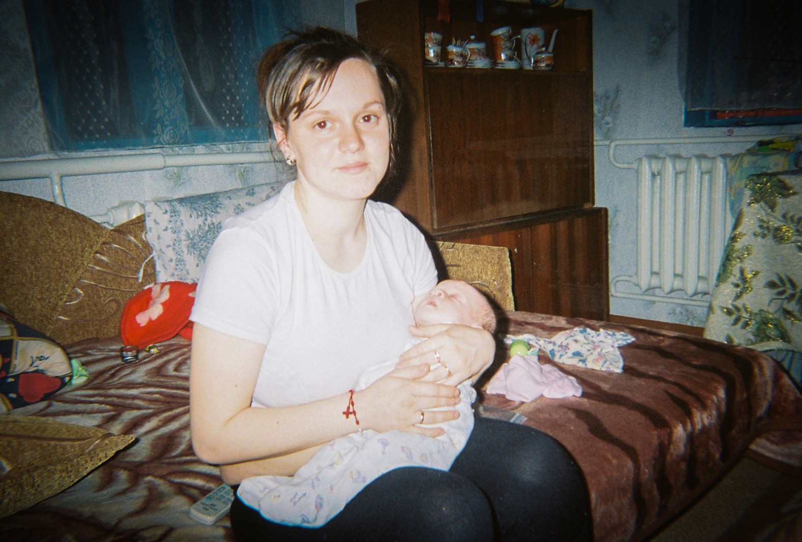 A mother and her newborn rest in their house in the Chernobyl region