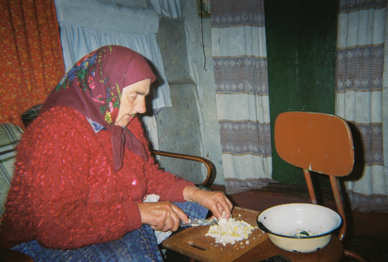 An elderly lady prepares home-grown food in her home near Chernobyl